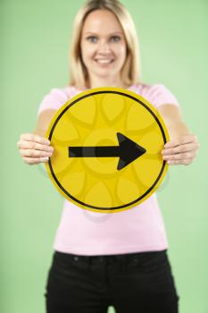 Royalty Free Photo of a Woman With an Arrow Sign