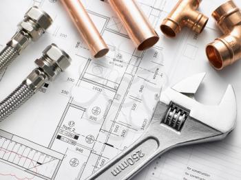 Royalty Free Photo of Plumbing Equipment on House Plans
