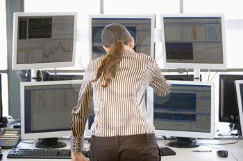 Royalty Free Photo of a Stock Trader Looking at Monitors