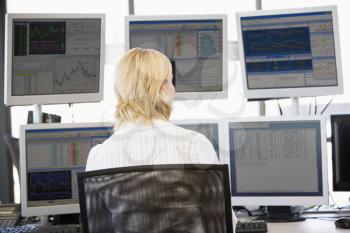Royalty Free Photo of a Stock Trader Looking a Monitors