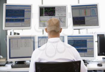 Royalty Free Photo of a Stock Trader Looking at Monitors