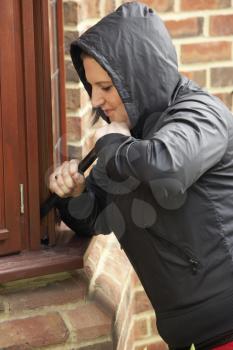 Royalty Free Photo of a Woman Breaking Into a House