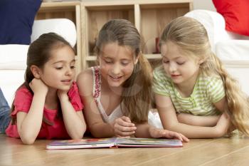 Royalty Free Photo of Little Girls Reading a Book