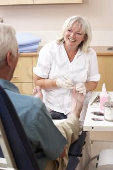 Royalty Free Photo of a Chiropodist With a Patient