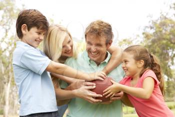 Royalty Free Photo of a Family Playing Football