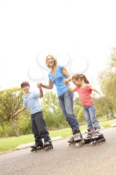 Royalty Free Photo of a Grandmother Roller Skating With Her Children