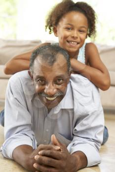 Royalty Free Photo of a Grandfather on the Floor With His Granddaughter