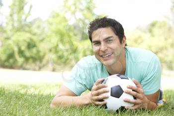 Royalty Free Photo of a Man on the Grass With a Soccer Ball