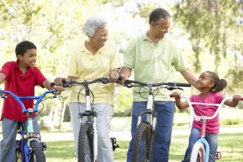 Royalty Free Photo of Grandparents With Grandchildren on Bikes