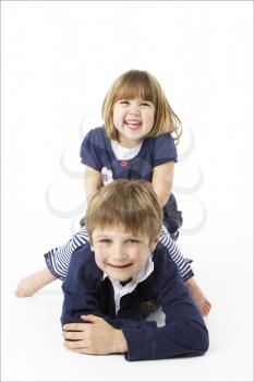 Studio Portrait Of Happy Brother And Sister