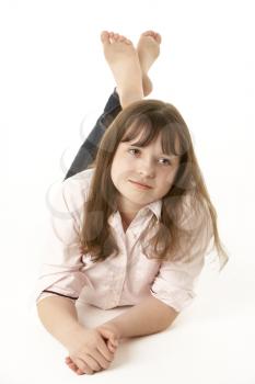 Thoughtful Young Girl Lying On Stomach In Studio
