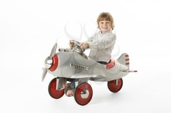 Young Boy Sitting In Toy Aeroplane