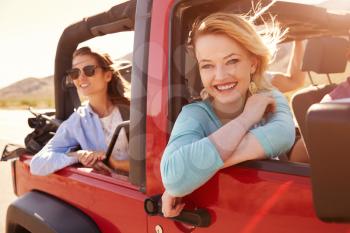 Two Female Passengers On Road Trip In Convertible Car