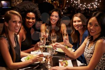 Group Of Female Friends Enjoying Meal In Restaurant