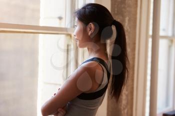 Businesswoman Looking Out Of Office Window