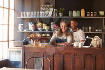 Portrait Of Couple Running Coffee Shop Behind Counter