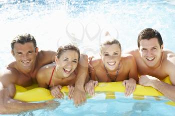 Group of Young friends having fun in pool