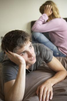 Teenage Couple In Bedroom After Argument
