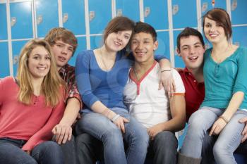 Teenage Students Relaxing By Lockers In School