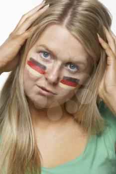 Disappointed Young Female Sports Fan With German Flag Painted On Face