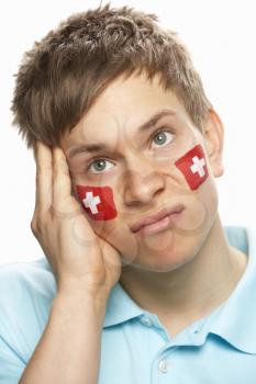 Disappointed Young Male Sports Fan With Swiss Flag Painted On Face