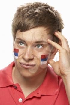 Disappointed Young Male Sports Fan With Serbian Flag Painted On Face