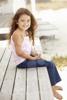 Little girl outdoors holding starfish