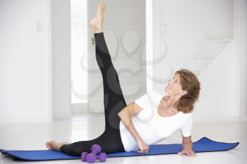 Senior woman exercising in home gym