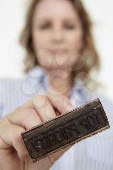 Businesswoman with rubber stamp
