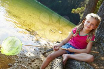Happy girl fishing at lake