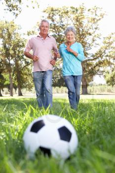 Senior couple playing football
