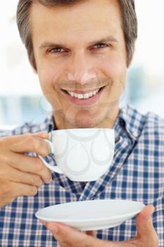 Man relaxing with cup of tea