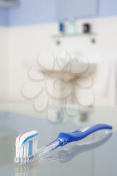 Toothbrush with toothpaste in bathroom