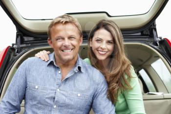 Couple outdoors with car