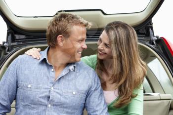 Couple outdoors with car