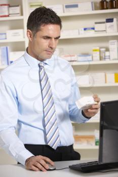 UK pharmacist working on computer