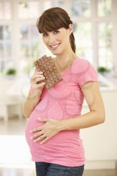 Pregnant woman eating chocolate