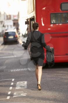 Businesswoman running for bus