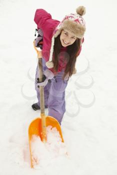 Teenage Girl Shovelling Snow From Path