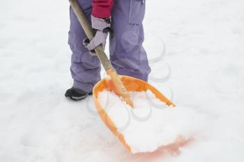 Close Up Of Teenage Girl Shovelling Snow From Path