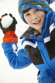Young Boy About To Throw Snowball Wearing Woolly Hat