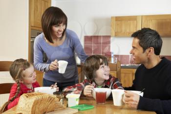 Family Eating Breakfast Together In Kitchen