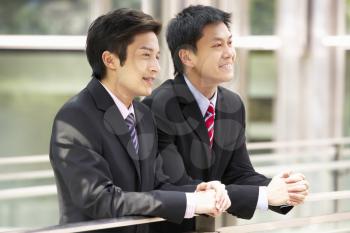 Two Chinese Businessmen Outside Modern Office