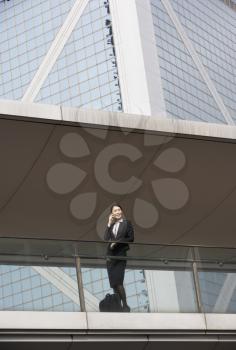 Chinese Businesswoman Outside Office On Mobile Phone