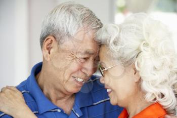 Loving Senior Chinese Couple Together At Home