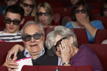 Senior Couple Watching 3D Film In Cinema