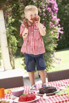 Boy Eating Jelly And Cake At Outdoor Tea Party