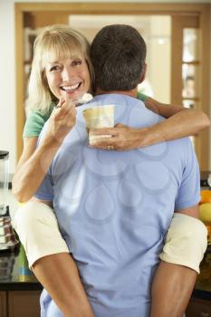 Romantic Senior Couple Hugging And Eating Ice Cream