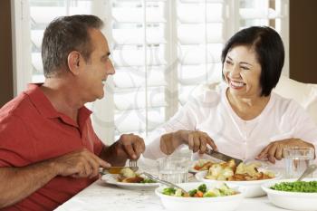 Senior Couple Enjoying Meal At Home