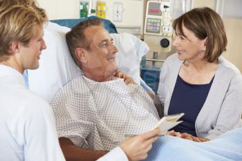 Doctor Talking To Couple On Ward